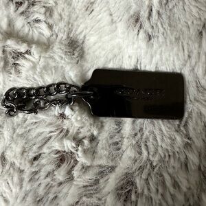 Gunmetal black Coach tag